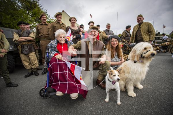 Picture by Sophie Rabey.  06-05-24.  The Guernsey Military Vehicle Group visited 104-year-old Helene Gallienne today at her home, ahead of Liberation Day.
L-R Helene Gallienne, Mat Broughton, Karen Broughton and dogs Benji and Kobe.