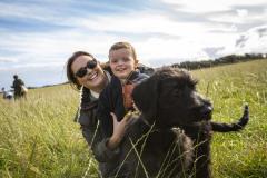 Picture by Luke Le Prevost. 23-09-23.
Schnauzer owners brought their dogs to Pleinmont for the Schnauzerfest charity event to meet up and walk together. L-R Harriet Armstrong, son Oscar (2) and 15-week old Winston