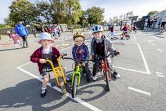 Picture by Sophie Rabey.  16-09-25.  La Mare De Carteret Primary School have had some new playground markings added over the summer break.  It was funded through the schools PTA and the Health Improvement Commission, with the hope to increase physical activity amongst the pupils and help their confidence on bikes etc.
L-R Isla Herve (5), CJ Wilson (4) and Oliver Brown (6)