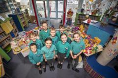 Picture by Sophie Rabey.  20-12-23.  Haute Capelles Primary School have collected donations for local charities as part of this years reverse advent calandar.
The House Captains chose GSPCA, The Sunflower Project, GROW and The Youth Commission, they are pictured alongside their tables of collections.
L-R Back: Solomon Bearder (10), Tabitha Cunningham (11), Ollie Lowe (11), Arden Carre (11).  Front: Oscar Le Flem (10), Chloe Falla (10), Olivia Dyer (10) and Marlee Bienvenu (10).