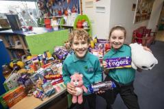 Picture by Sophie Rabey.  20-12-23.  Haute Capelles Primary School have collected donations for local charities as part of this years reverse advent calandar.
The House Captains chose GSPCA, The Sunflower Project, GROW and The Youth Commission, they are pictured alongside their tables of collections.
Mercury House chose The Sunflower Project L-R Solomon Bearder (10) and Marlee Bienvenu (10)