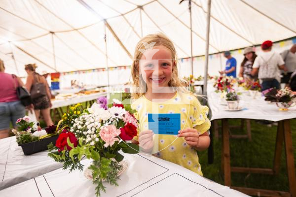 Picture by Sophie Rabey.  23-08-23.  First day of the North Show at Saumarez Park.
Maya Bailay (aged 7) with her second prized flower arrangement in a teacup.