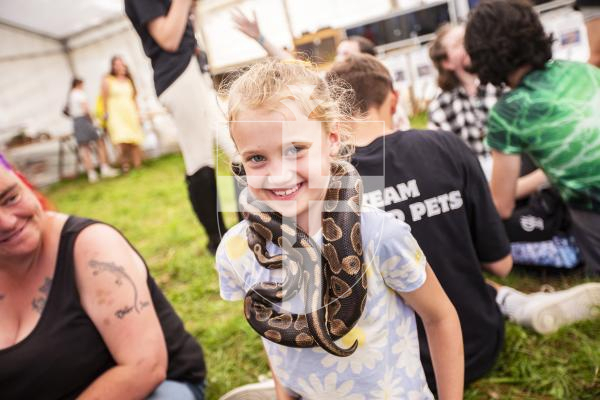 Picture by Sophie Rabey.  23-08-23.  First day of the North Show at Saumarez Park.
Elouise Boyd (aged 7) with a snake from The Reptile House, Island Pet Parties.