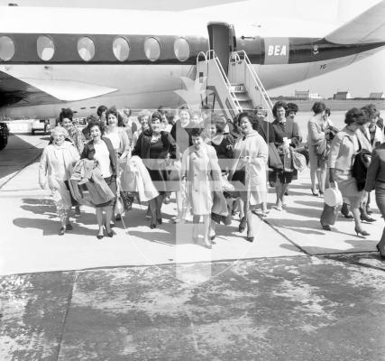 Picture by Guernsey Press.  65 women arrived by air from Belfast to be housed at St Peter's Church Hall in 1964.  They were recruited by the Guernsey Growers' Association for tomato packing.