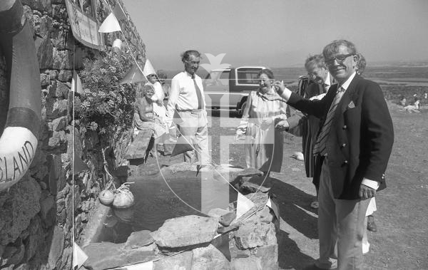 Picture by Guernsey Press.
Nostalgia Lookback feature.
17 Aug 1988. Neg number 2068/29a/88.
The Bailiff, Sir Charles Frossard, makes the first wish at Lihou's new wishing well in support of the Great Ormond Street wishing well appeal.
