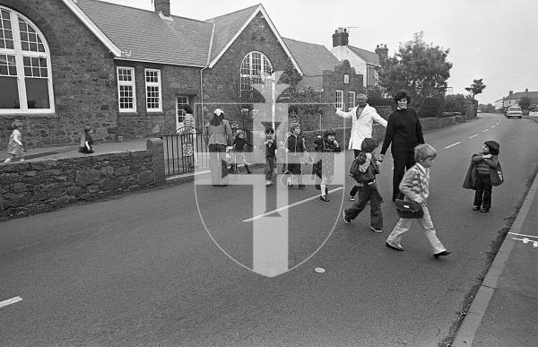Picture by Guernsey Press.
Nostalgia Lookback feature.
11 Oct 1978. Neg number 3996/78.
Daily supervised crossing at the Forest School. The Education Council considered erecting a bridge over the road, pedestrian-controlled traffic lights and a tunnel as alternative ways for students to cross the busy thoroughfare.