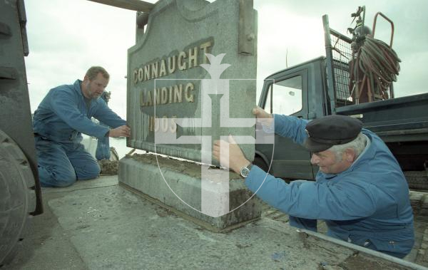 Picture by Guernsey Press.
Nostalgia Lookback feature.
13 Nov 1998. Neg number 2964/12/98.
The Connaught Stone, damaged by a car in 1997, has been refurbished by harbour staff. Peter Duport (left) and John Alder make sure the Connaught Stone is put back into its original place at the top of the Connaught slipway.