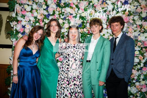 Picture by Luke Le Prevost. 29-06-23.Grammar School Yr 11 Prom 2023 at The Farmhouse. L-R Kaitlin Naftel, 16, Lucy Bridges, 16, Mrs Claudia Aguiar-Hemom, Elise Child, 16, and Ziggy Pearce, 16