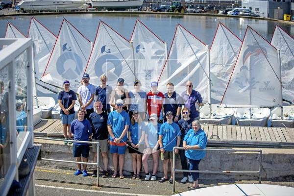 Picture by Peter Frankland. 11-08-24 Association of Sail Training Organisations boats have arrived in St. peter Port ahead of Monday's Royal visit with Sophie, Duchess of Edinburgh. Pictured about to have a go at sailing Optimist dinghys on the model yacht pond are young sailors who are over with the Morning Star Trust on two boats, Eastern Star and Guiding Star. Far right is ASTO Chief Exec Kerry McMillan.