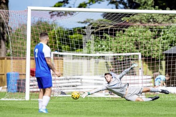 Picture by Peter Frankland. 23-08-24 Football at St Peter's. Sylvans v Rovers. Rovers keeper tips this shot around the post.