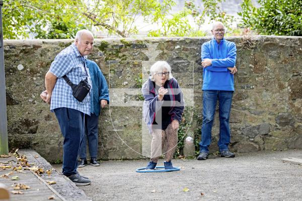 Picture by Sophie Rabey.  10-10-25.  Parkinsons Guernsey held a Petanque Session at the college field for people to give the game a go.
L-R Andrew Bisson, Sue Whitlock (throwing) and William Mayer.